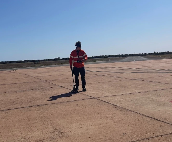 Technician tests airport concrete slab - SureScan concrete scanning services - Brisbane & Adelaide